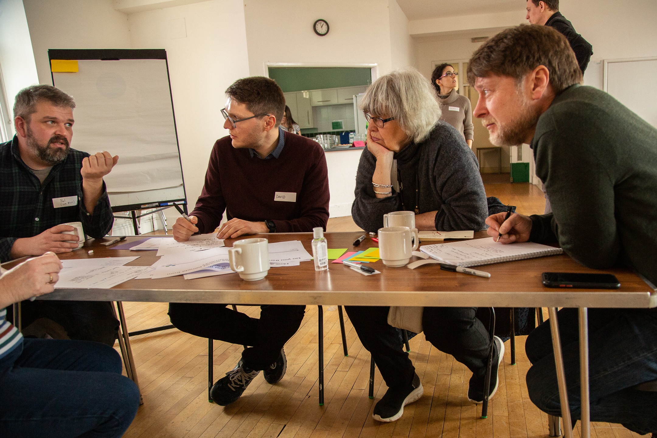 workshop attendees discussing around a table